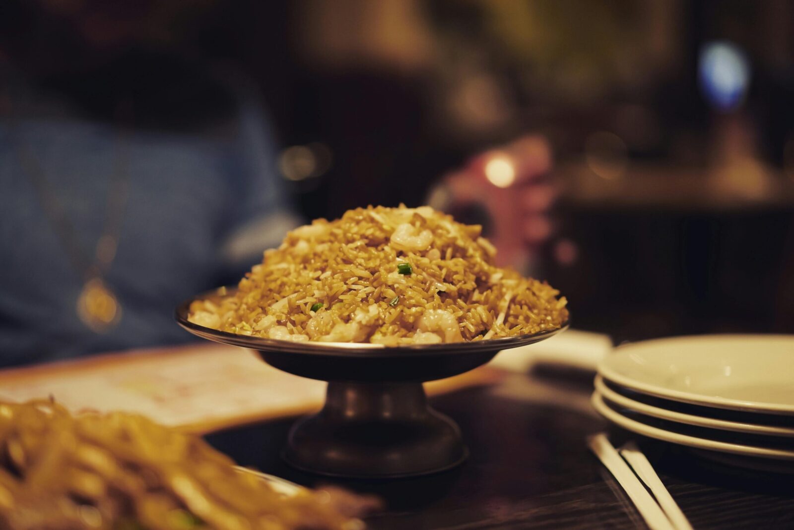 Close-up of shrimp fried rice served on a pedestal dish, ideal for food photography.